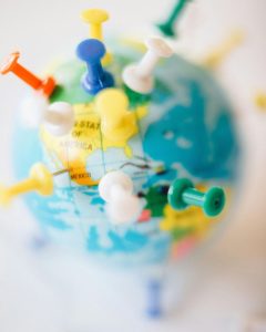 Photo by Nataliya Vaitkevich: https://www.pexels.com/photo/blue-red-and-yellow-plastic-toy-7236025/

Photo of a globe with colourful pins pinned all over it.