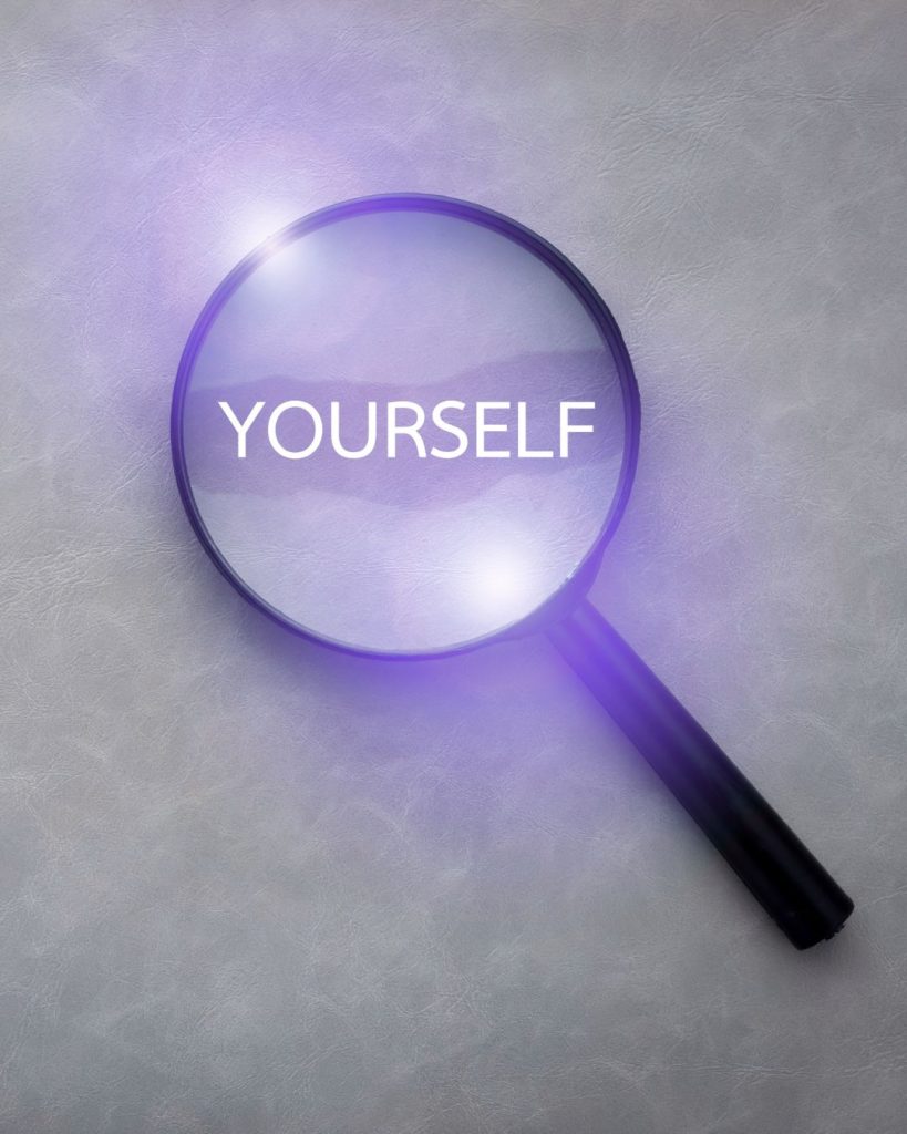 8-Science-backed-benefits-of-travelling-solo Photo of a black plastic magnifying glass focusing on the word "yourself".